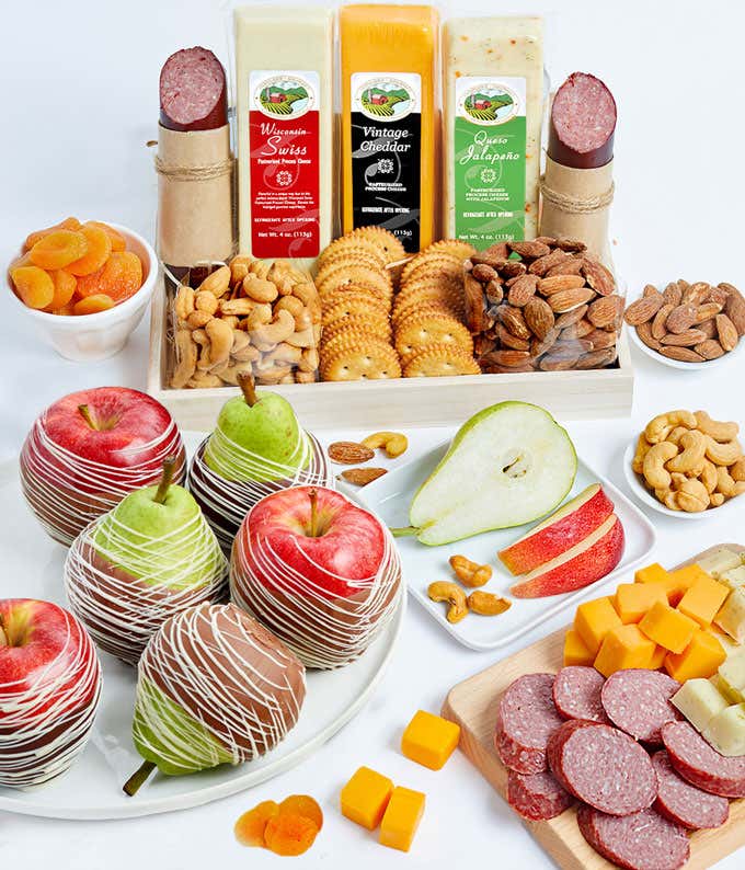 Gift basket with chocolate dipped apples, chocolate dipped pears, summer sausage, vintage cheddar cheese, Wisconsin Swiss cheese, queso jalapeño cheese, almonds, cashews, dried apricots, and snack crackers.