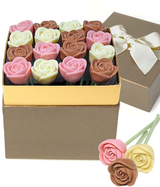 Valentine&rsquo;s Day chocolate rose gift box featuring red and milk chocolate rose-shaped candies arranged in a gold-trimmed box, with a ribboned gift lid and two chocolate rose pops displayed in front.