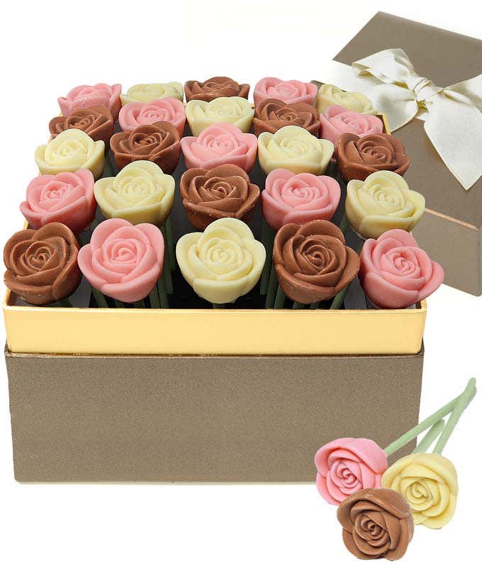  chocolate rose gift box featuring red and milk chocolate rose-shaped candies arranged in a gold-trimmed box, with a ribboned gift lid and two chocolate rose pops displayed in front.