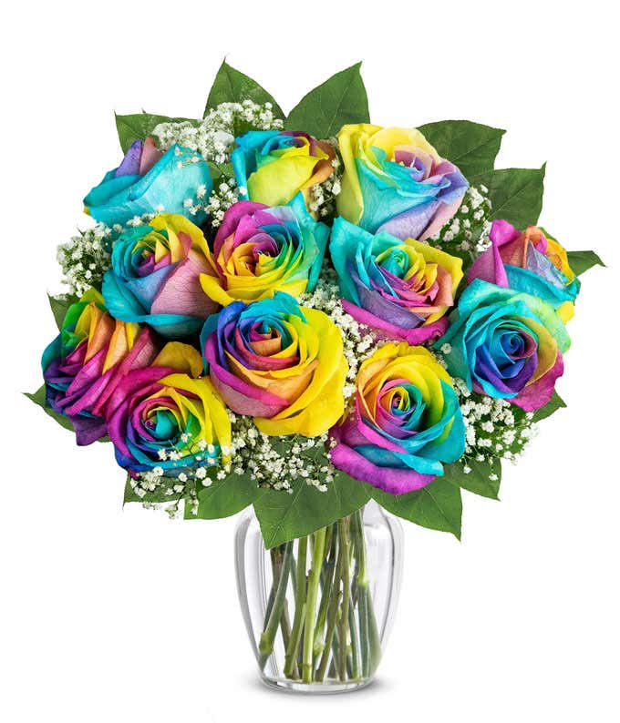 A stunning arrangement featuring 12 wild rainbow roses, optionally presented in a vase. This vibrant and colorful display creates a striking and eye-catching centerpiece, perfect for adding joy and celebration to any occasion.