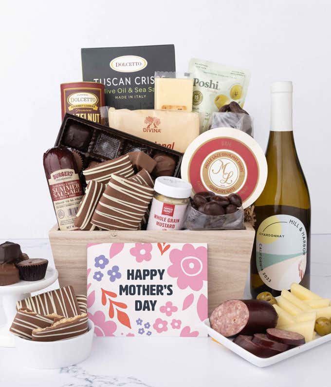 Wooden Mother’s Day gift crate filled with a bottle of Hill & Harbor Chardonnay, summer sausage, brie, cheeses, Tuscan crisps, chocolates, pretzels, and gourmet snacks, displayed with a Mother’s Day card.